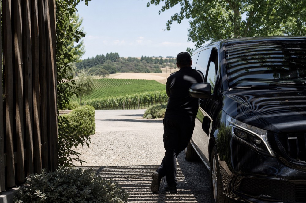 A private tour van parked at a Dundee Hills winery entrance