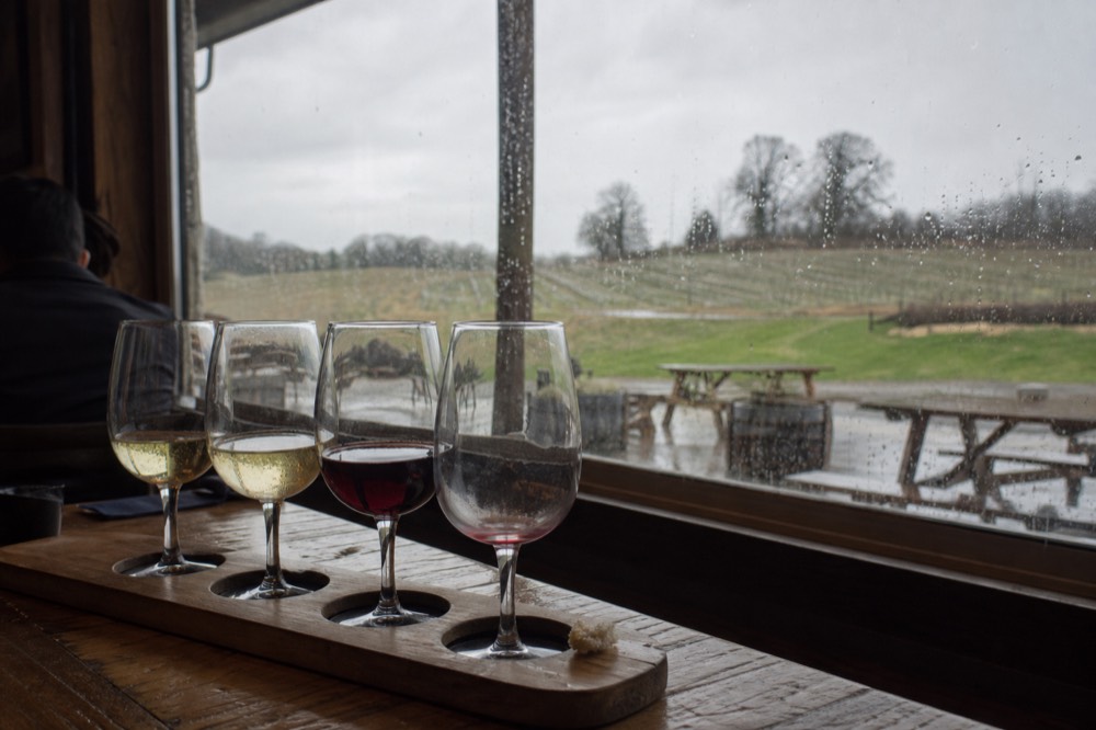 Tasting flight of Pinot Noir and Chardonnay on a wooden table
